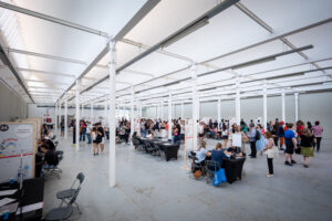 Vista general de GiraFeina 2025 a Roca Umbert amb joves, estands i entrevistes en curs